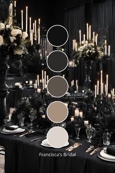 the table is set with black and white plates, silverware, candles, and flowers