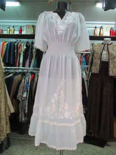 "Wonderful 70s white Romanian dress. Sheer fabric. It features traditional embroidery on chest, sleeves and skirt. Smocking neckline and elasticated waistband (pics 2-3). Beautiful raglan cup sleeves (pic.5). Skirt lesftside rip (pic.7). It is refined all around (neckline, sleeve-ends, rip and hem) with crochet pattern. It can be a wedding dress. It's a very beautiful dress. Mint conditions. It fits size S-M Measurements: (lay flat and double chest and waist) Shoulders 14.2\"-15.7\" chest 32.2\" Rip Pic, Romanian Dress, Twiggy Fashion, White Sheer Dress, Cup Sleeves, Traditional Embroidery, Dress Mint, Dress Embroidery, Cape Sleeves