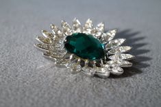 I am offering this fabulous vintage multi round large emerald green brooch. This piece is truly gorgeous, and it has the following features: * beautiful vintage pin * rhinestone flower * silver tone * 2 inches This is a fantastic and classic piece. There is tons of sparkle and shine with this piece. It will beautifully complement your upcoming fashion season. Buyer pays all shipping and handling. Green Brooch, Rhinestone Flower, Brooch Jewelry, Green Flower, Jade Stone, Genuine Turquoise, Fashion Seasons, Vintage Pins, Green Flowers