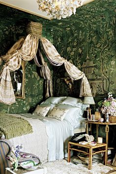 a bedroom with green walls and floral wallpaper on the walls is decorated in an antique style