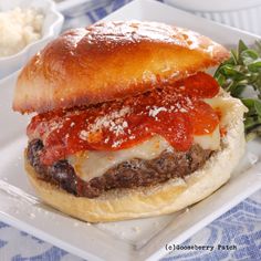 a cheeseburger with tomato sauce and bread on a plate