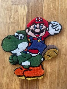 the rug is shaped like an animal with mario on it's back and other cartoon characters