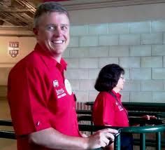 a man standing next to a woman in red shirts