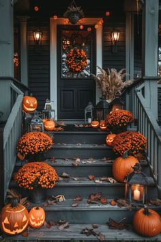 pumpkins and gourds on the steps of a house decorated with lights for halloween