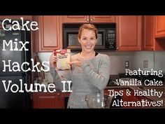 a woman holding up a box of cake mix in her kitchen with the words, cake mix hacks volume ii