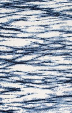 an abstract blue and white area rug with wavy lines on the top, bottom and bottom