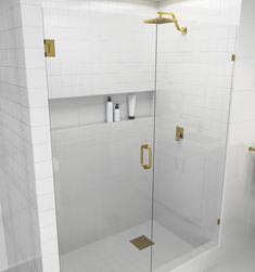 a bathroom with a glass shower door and white tiles on the walls, along with gold handles