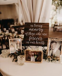 a table topped with pictures and framed photos next to a sign that says in loving memory of those one forever in our hearts