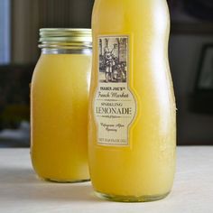 two jars filled with liquid sitting on top of a table