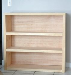 a wooden shelf sitting on top of a tiled floor