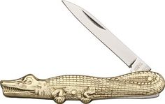 a gold alligator knife with a black handle