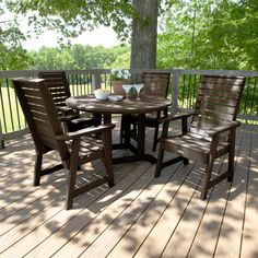 an outdoor table and chairs on a deck