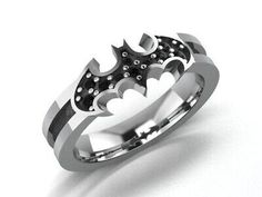 a batman ring is shown on a white surface with black diamonds in the center and silver accents