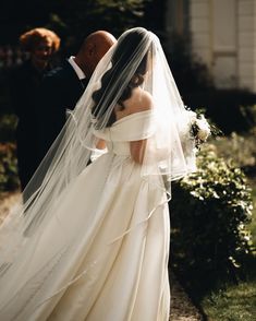 the bride and groom are walking down the path