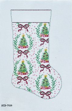 a cross stitch christmas stocking with a tree on it