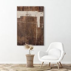 a white chair sitting next to a potted plant