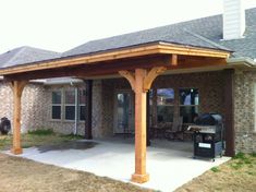 an outdoor covered patio with grilling area