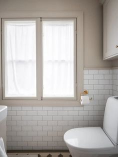 A modern bathroom with gold fixtures and a shower niche