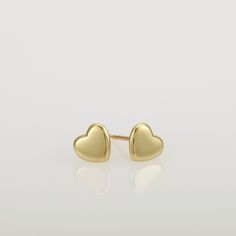 These are small gold heart earrings, handmade of 14k solid gold. Modern yellow gold heart stud earrings, with a highly shiny finish. These heart studs are perfect for every day's wear, and will look great with any style. They will add a chic gold touch and sparkle to your appearance. A wonderful gift for yourself or for someone you love. Heart's size is approx 6.8 x 6.2 mm = 0.26 x 0.24 inch Heart is 1.4 mm thick = 0.05 inch. 14k solid gold ear backs are included. *I can make these earrings in m Minimalist Gold Heart Earrings With Charm, Gold Minimalist Heart Earrings For Everyday, Dainty Yellow Gold Heart Earrings For Everyday Wear, Minimalist Gold Hypoallergenic Heart Earrings, Minimalist Gold Heart Pendant Earrings, Tiny Dainty Yellow Gold Heart Earrings, Dainty Tiny Yellow Gold Heart Earrings, 14k Yellow Gold Open Heart Earrings, Dainty Yellow Gold Sterling Silver Heart Earrings