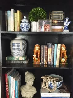 a book shelf filled with books and vases