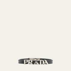 This Saffiano leather bracelet by Prada with a modern design is defined by the metal lettering logo. Made in Italy. Luxury Formal Name Bracelet, Modern Formal Bracelet With Logo Charm, Modern Formal Bracelets With Logo Charm, Luxury Leather Jewelry With Logo Charm, Designer Formal Bracelets With Logo Charm, Designer Formal Jewelry With Logo Plaque, Modern Leather Bracelets, Designer Leather Bracelet, Luxury Leather Bracelets For Business