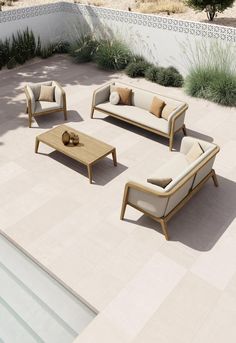 an outdoor seating area with couches and coffee table