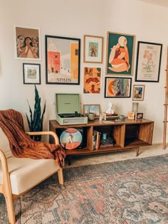 a living room filled with furniture and pictures on the wall next to a book shelf