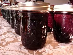 four jars are lined up on the table