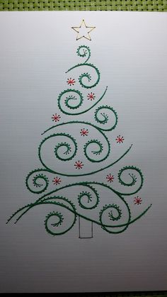 a drawing of a christmas tree with green and red swirls on white paper,