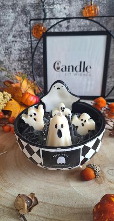 halloween candles in a bowl with ghost decorations