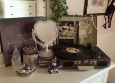 there is a record player, figurine and other items on the table in this room