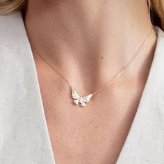 Embrace the delicate beauty of nature with our Diamond Butterfly Necklace. This enchanting minimalist piece features a solid gold butterfly pendant, meticulously crafted to capture the intricate details of its wings. Natural diamonds are flush-set throughout the pendant, creating a subtle yet captivating sparkle that dances with every movement. Suspended from a dainty gold chain, this butterfly necklace is a timeless symbol of transformation, joy, and effortless elegance. Whether you're adding a touch of whimsy to your everyday look or seeking a meaningful gift for a loved one, this necklace is sure to become a cherished treasure. - Handmade - Solid Gold - Natural Diamonds - G Color, SI Quality Diamonds - The Dimension of the Butterfly: 13.42 mm x 21.80 mm - Total Diamond Carat Weight: 0.3 Diamond Butterfly Necklace, Flush Set Diamond, Minimalist Jewellery, Diamond Butterfly, Butterfly Pendant Necklace, Delicate Beauty, Everyday Necklace, Diamond Chain, Gold Butterfly