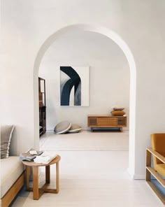 a living room filled with furniture and white walls