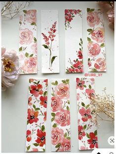 flowers are painted on white paper with pink and red flowers in the center, along with other papers