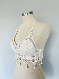 Welcome to giZZdesign! New white crochet crop top all perfectly finished by knit. This gothic crochet halter top is fully adjustable by the strings that ties around the neck. I don't smoke and I carry out my designs in a non-smoking atelier. Unfo, colours are tempted to seem different in any different screen. I kindly remind you that the measurements can be slighlty different beacause it is handmade. GIFTS If you would like to send this item as a gift please just inform me. Let me know if you would like to add a special note to the item. Ready products are given to post office within 1-3 days and delivery depends on your address. Product Details Hand-knitted 95% Cotton, %5 Polyester Color: WHITE Caring Information: Wash with similar colours. Wash on the reverse side. Iron on the reverse si White Crochet Lace Crop Top, White Cropped Crop Top With Crochet Lace, White Bohemian Halter Top With Crochet Lace, Vacation White Crochet Lace Halter Top, White Crochet Lace Triangle Top, White Crochet Crop Top For Vacation, White Crochet Lace Halter Top For Vacation, White Knitted Sleeveless Crop Top, White Fitted Crochet Lace Crop Top