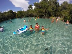 several people are swimming in the water with boogie boards