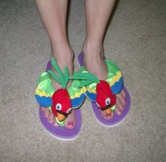 the feet of a person wearing sandals with birds on them