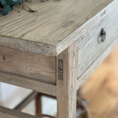 an old wooden table with flowers on top