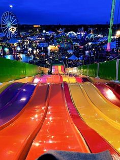 an amusement park filled with colorful slides at night