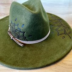 This Beautiful Green Wool Felt Fedora Is A Must-Have Addition To Your Wardrobe. The Handmade Floral Mandala Design Is Custom Made And Adds A Touch Of Uniqueness To The Hat. The Wide Brim Is Perfect For Sunny Days And The Wool Burned Accents Give It A Rustic Touch. The Hat Is From The Universal Thread Brand And Is One Size Fits All. It Is Made Of High-Quality Wool Material And Is Perfect For Women Who Love To Accessorize. Personalized With Custom Art Making It Even More Special. Get Ready To Turn Heads With This Gorgeous Hat! Used In Like New Condition Floral Mandala Design, Floral Mandala, Felt Fedora, Art Making, Hat Women, Green Wool, Wide Brimmed Hats, Brim Hat, Wool Hat