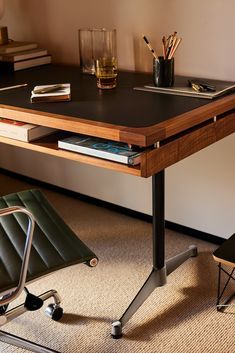 a desk with a chair and some books on it