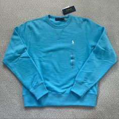 This Polo Ralph Lauren Crewneck Pullover Sweatshirt In Sky Blue Is Such A Great Versatile Piece. It Has Super Soft And Comfortable Fleece Fabric Making It Perfect For Lounging Around, Or You Can Dress It Up A Bit With Jeans Or A Button Down Underneath. Sky Blue Color With White Polo Logo. Nwt, Never Worn. Size Children’s M, But Could Also Fit A Women’s Xs. Feel Free To Make An Offer And Check Out My Other Listings To Bundle! Ralph Lauren Crewneck, Hoodie Jacket Women, Polo Ralph Lauren Hoodie, Ralph Lauren Hoodie, Ralph Lauren Pullover, Sky Blue Color, Polo Logo, Kids Fleece, Hoodie Logo