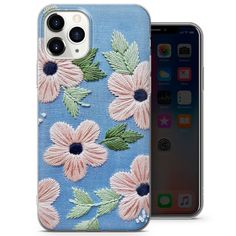 an iphone case with pink flowers on blue fabric