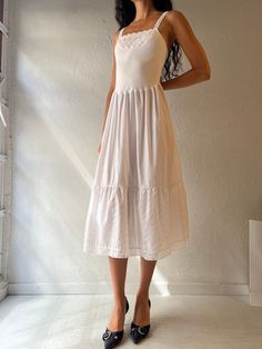 - Vintage Jessica white midi dress - Cotton poly blend - Made in Canada - Tagged 36 Bust: 15.5" Waist: 13.5" Length: 48" We are not responsible for lost, stolen, or damaged packages once they have been shipped. Any additional customs duties or taxes incurred on international orders are the responsibility of the buyer. Please note that our items are vintage and may have minor flaws or imperfections due to their age, which adds to their unique character. Fitted Tea-length Midi Dress For Daywear, Fitted Midi Sundress For Daywear, Fitted Midi Length Sundress For Daywear, Summer Tea-length Midi Dress With Ruffles, Sundress Style Midi Dress For Brunch, White Midi Dress For Spring, Fitted Knee-length Sundress For Daywear, White Mid-length Maxi Dress For Summer, White Fitted Knee-length Sundress