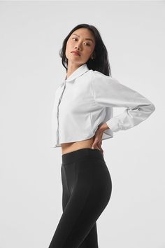 The Cropped Take Me Out Button Up is a year-round layer to wear on repeat. Made with a twill woven that’s lightweight yet warming along with hidden buttons for a sleek look, this cropped and collared long sleeve is the shacket, reimagined. Layer it over a bra top and leggings for an instant outfit that wears well anywhere. Fitted Cropped Long Sleeve Shirt For Daywear, Spring Classic Fitted Cropped Shirt, Classic Cropped Shirt For Daywear, Fitted Cropped Shirt For Work, Classic Fitted Cropped Shirt For Spring, Fitted Tops With Button Cuffs For Everyday, Fitted Top With Button Cuffs For Everyday, Alo Yoga Fitted Everyday Tops, Alo Yoga Fitted Tops For Everyday