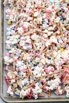 sprinkles and marshmallows are mixed together on a baking sheet