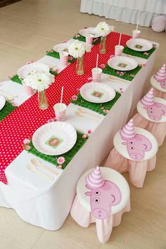 a table set up with pink and white decorations