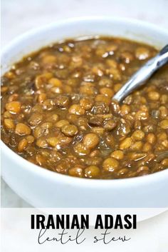 a white bowl filled with baked beans on top of a table