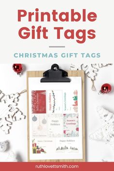 the printable christmas gift tags on a clipboard next to ornaments and other decorations