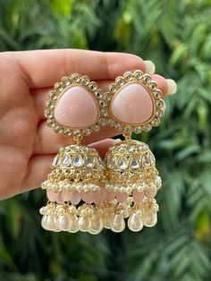 Beautiful engraved Jhumka earrings available in 2 stunning variations of pink. These earrings are high quality and are made to last. They are not too heavy and will be fine to wear all day long. They surely add a statement to any look! In case of any queries, please feel free to reach out. Happy shopping! Luxury White Jhumkas With Latkans, Luxury Tilla Jhumkas For Eid, Luxury Jhumkas With Intricate Design For Anniversary, Luxury Hand Set Jhumkas For Diwali, Cheap Jhumkas For Diwali Celebration, Luxury Fusion Style Chandelier Earrings With Latkans, Luxury Hallmarked Fusion Jhumkas, Luxury Jhumkas With Stone Work For Festivals, Luxury Fusion Style Cutdana Jhumkas